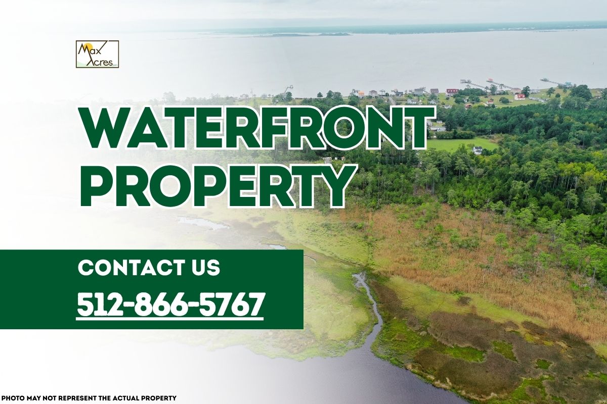 Aerial view of waterfront land with trees and shoreline, overlaid with text reading "Waterfront Property – Contact 512-866-5767" by Max Acres.
